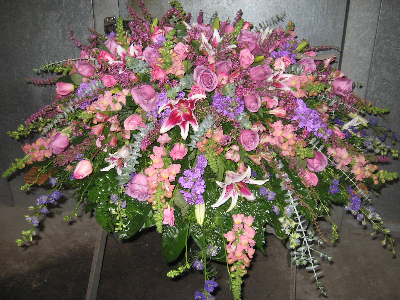 Shades of lavenders and pinks fill this design with a soft feeling. Some of these florals are seasonal and only available in the spring in our area. This piece as pictured starts at $500 however, something similar can be made in lower budgets.